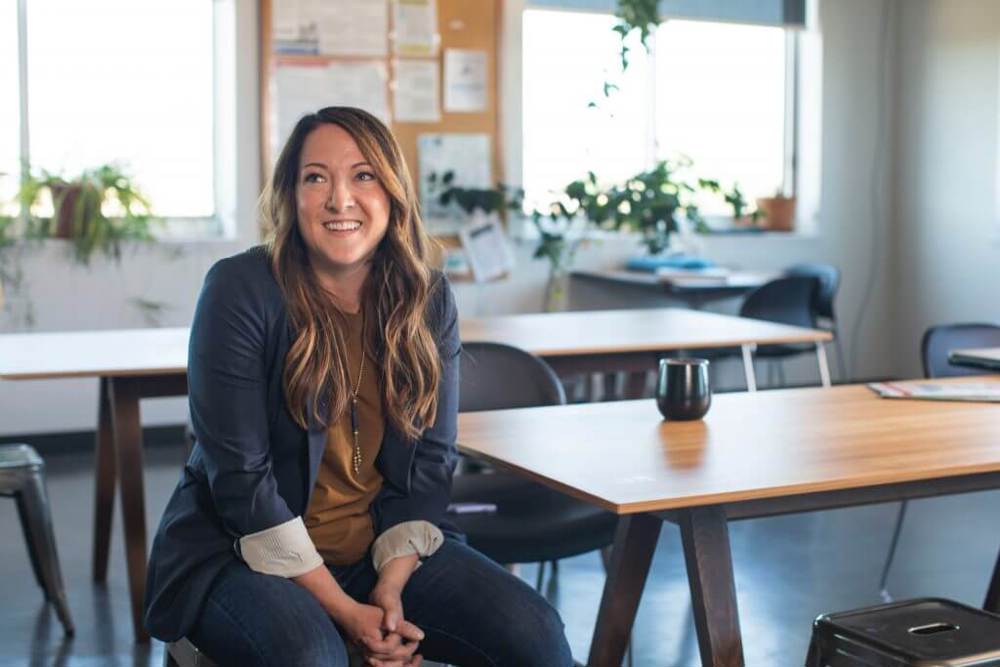 Woman sat at table smiling