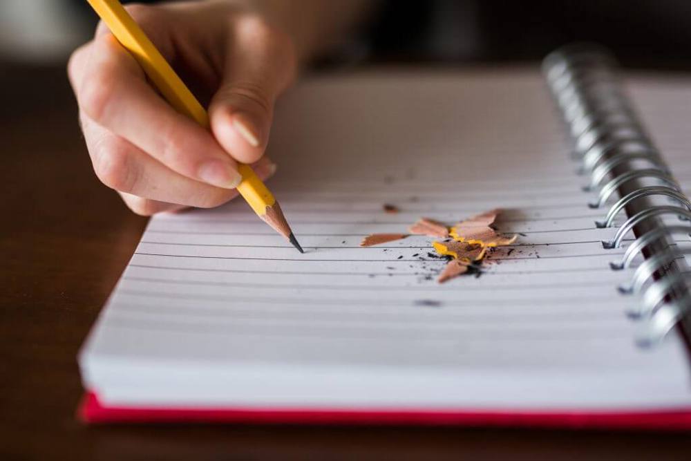 Yellow pencil and notebook