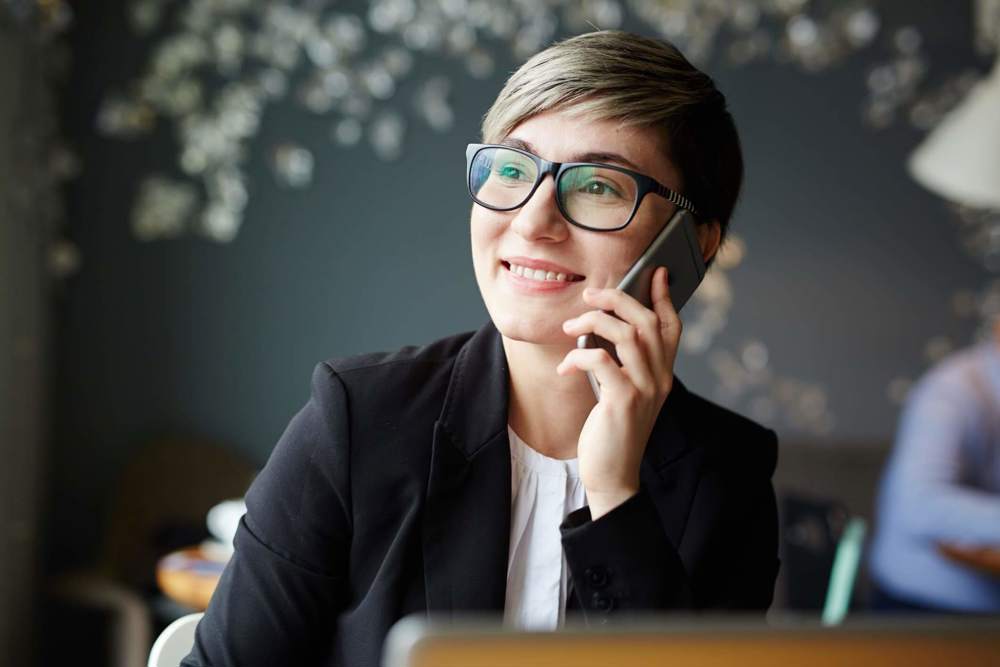 Woman on mobile phone smiling